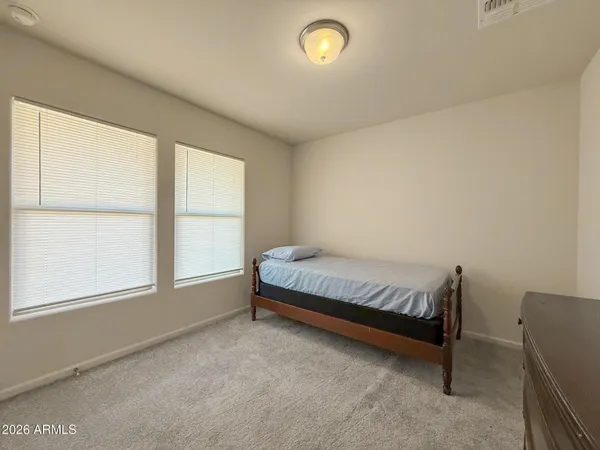a spacious bedroom with a bed and a window