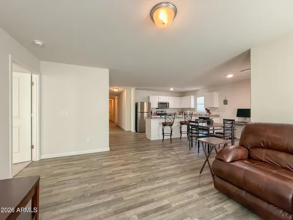 a living room with furniture and kitchen view