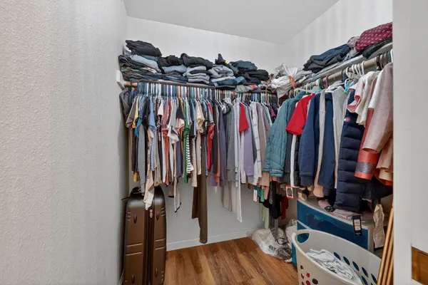 a view of walk in closet with clothes