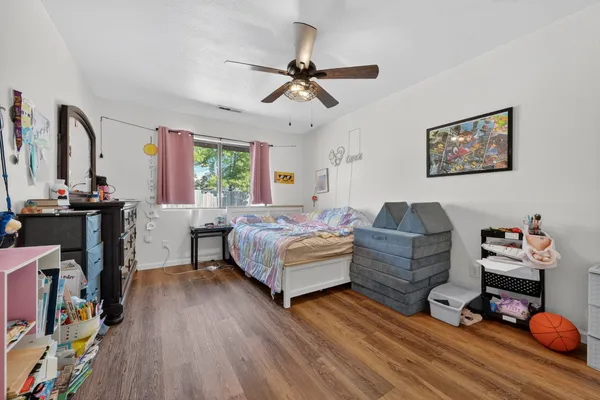 a living room with furniture and a wooden floor