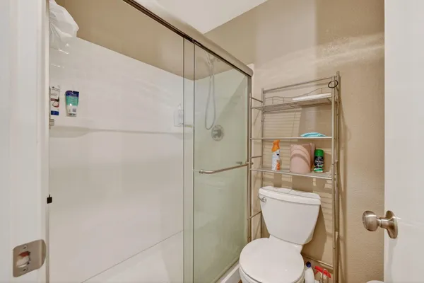 a white toilet sitting next to a bathroom sink