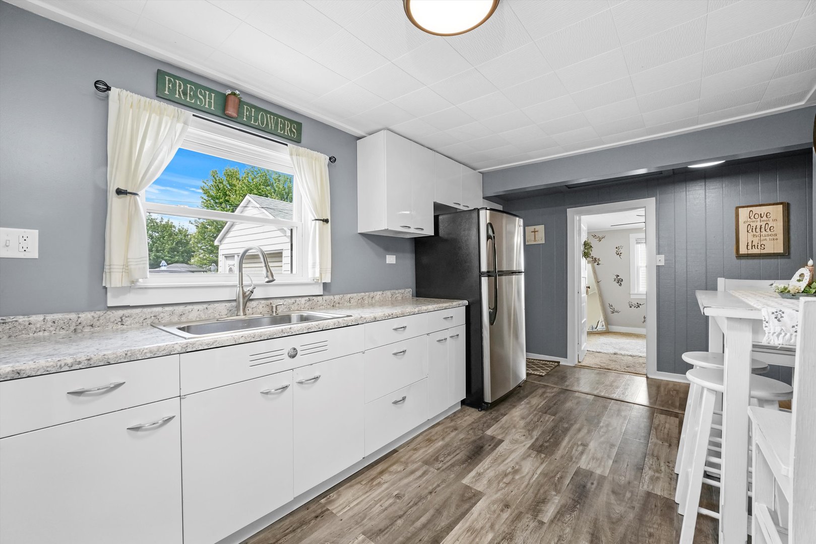 635 Birch Drive Beecher, IL 60401 - Photo 5 of 14 a kitchen with granite countertop a refrigerator a sink white cabinets and wooden floors