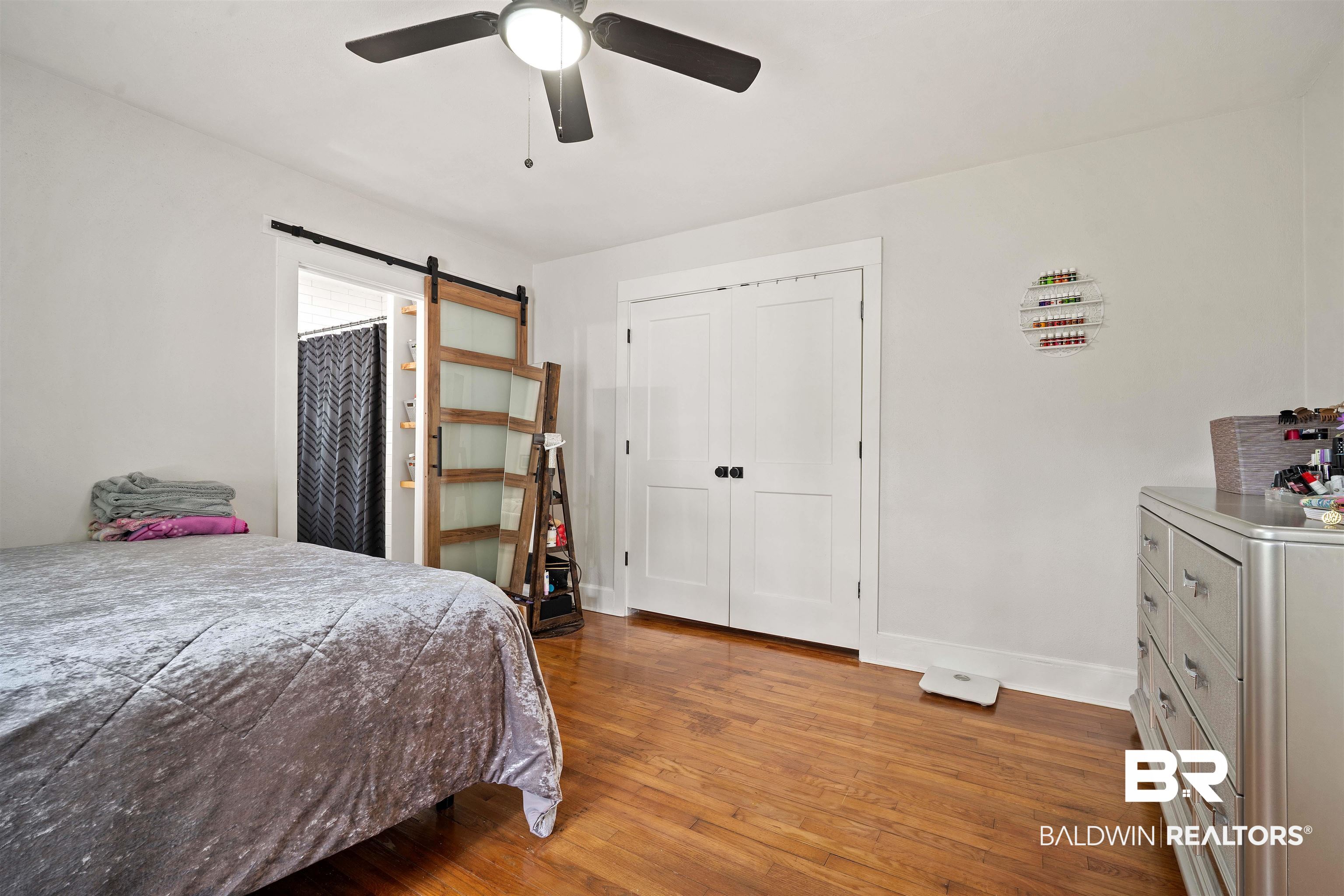 103 Emogene Place Mobile, AL 36606 - Photo 15 of 32 Bedroom featuring dark wood-style floors, ceiling fan, and a barn door