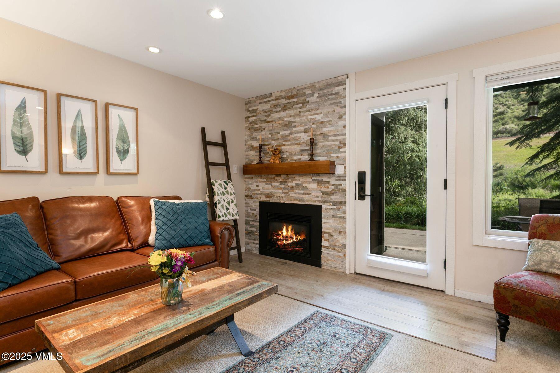 a living room with furniture and a fireplace