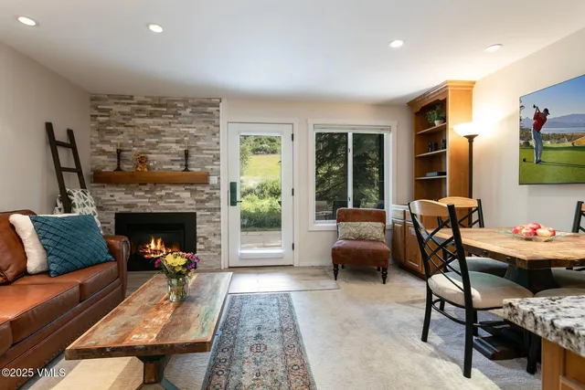a living room with furniture fireplace and a table