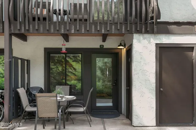 a view of a patio with table and chairs