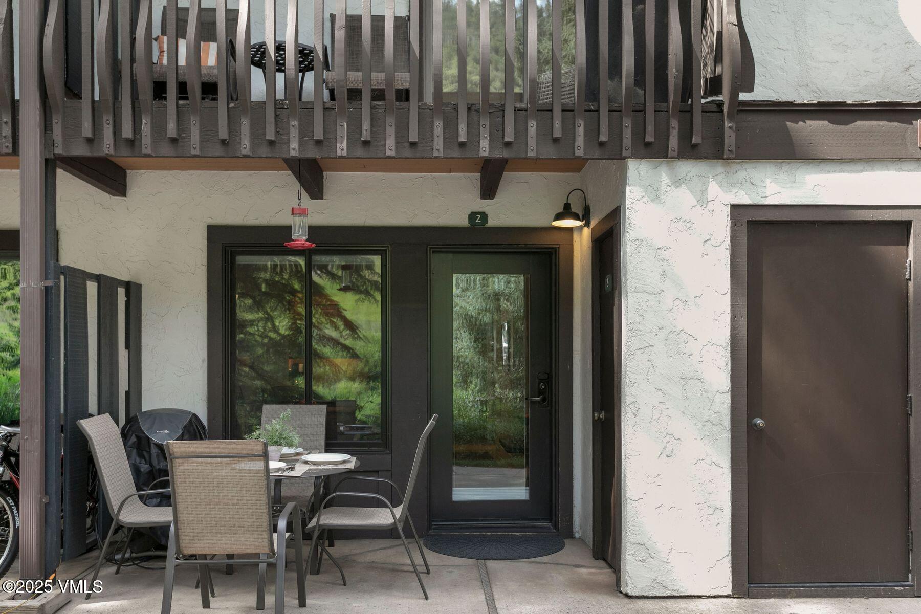 4610 Vail Racquet Club Drive, Unit 2 Vail, CO 81657 - Photo 14 of 28 a view of a patio with table and chairs