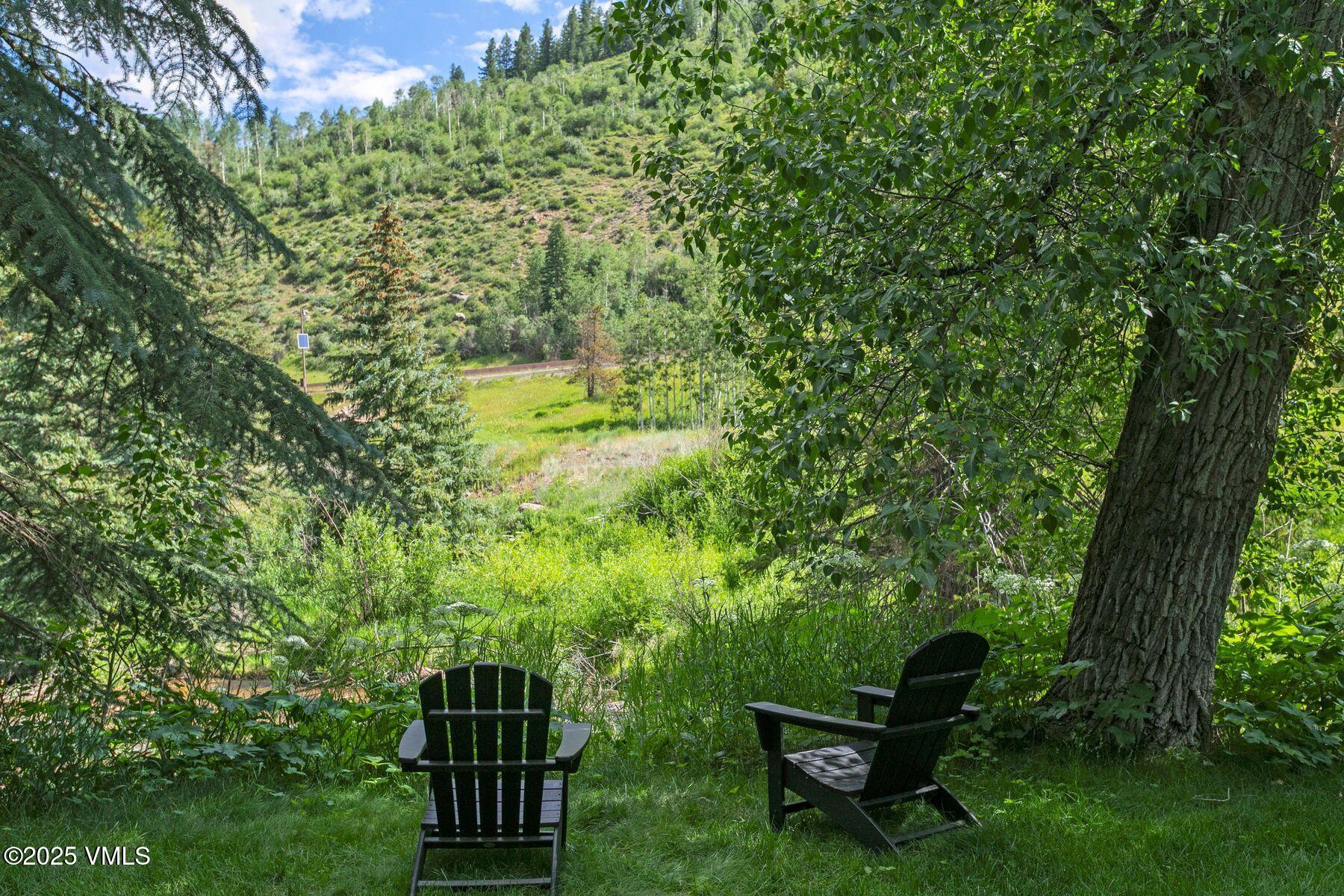 4610 Vail Racquet Club Drive, Unit 2 Vail, CO 81657 - Photo 17 of 28 a view of a bench in a garden