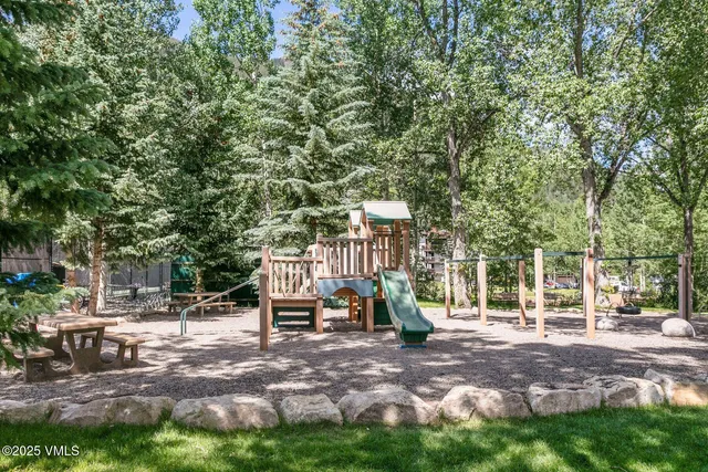 a view of a park with bench and trees