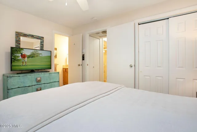 a bedroom with a bed and a flat screen tv