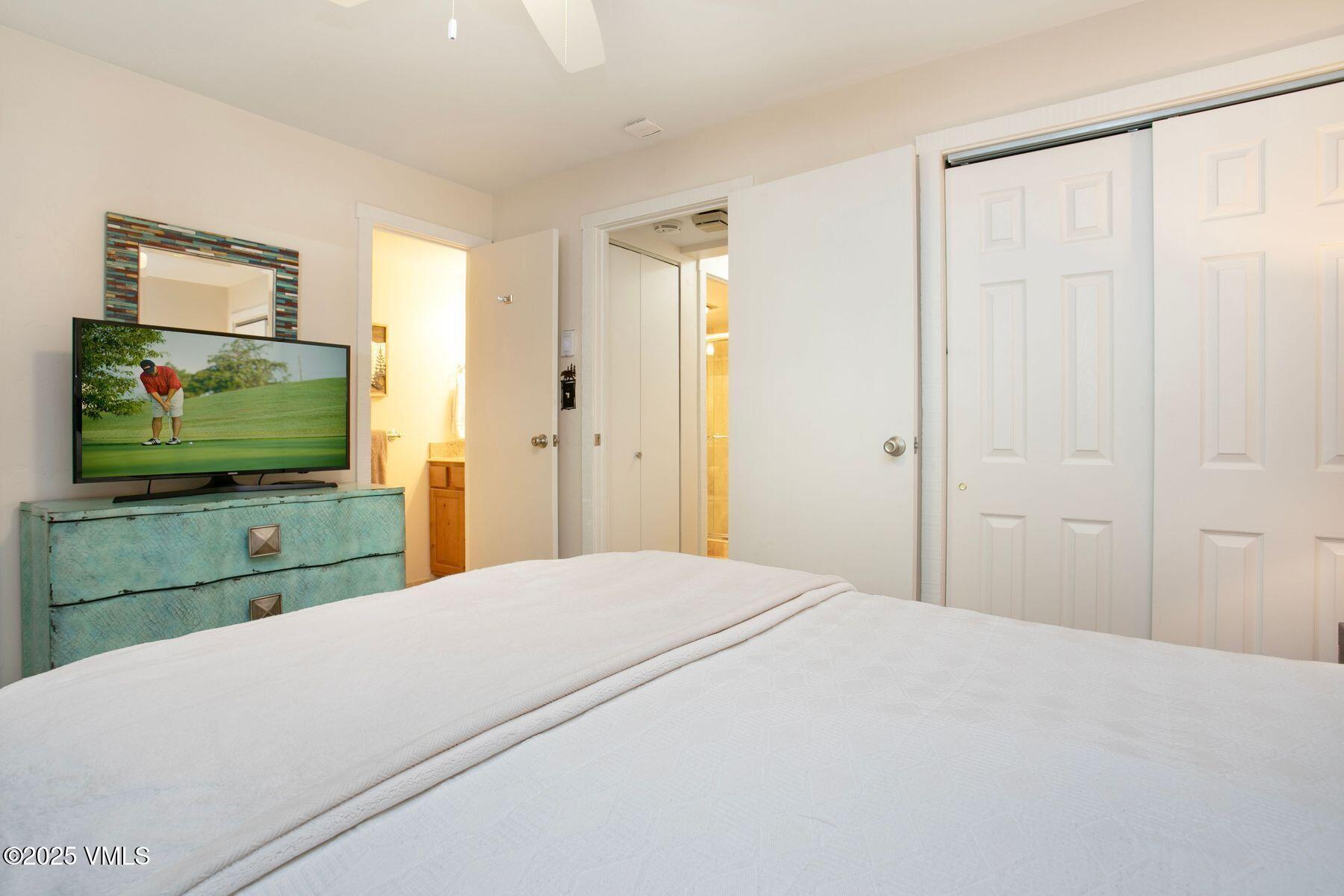 4610 Vail Racquet Club Drive, Unit 2 Vail, CO 81657 - Photo 10 of 28 a bedroom with a bed and a flat screen tv