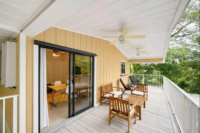 a view of balcony with wooden floor and stairs