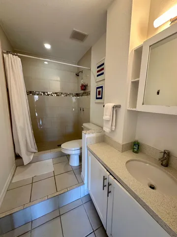 an aerial view of a house with a yard lake lake view and mountain view