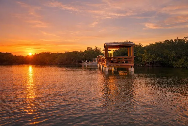 a view of a terrace with chairs and an umbrella