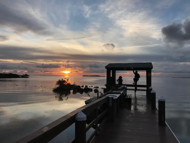 a kitchen with stainless steel appliances granite countertop a sink refrigerator and microwave