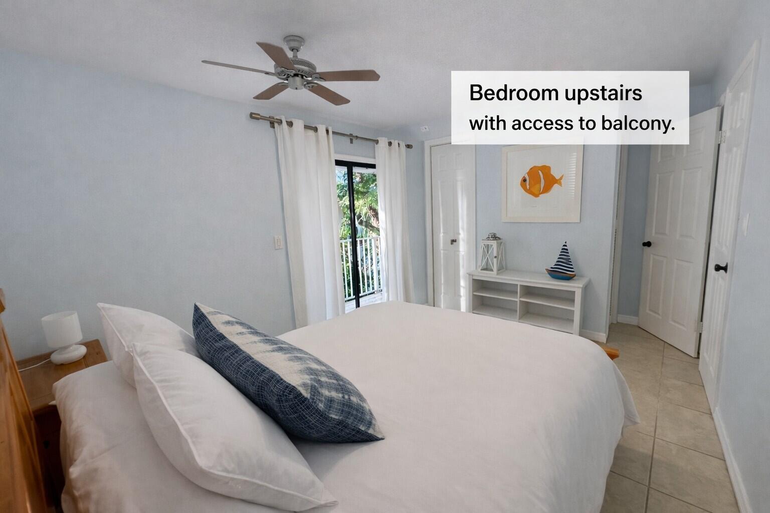 335 Bayview Avenue Key Largo, FL 33037 - Photo 8 of 57 a bedroom with a bed and a chandelier