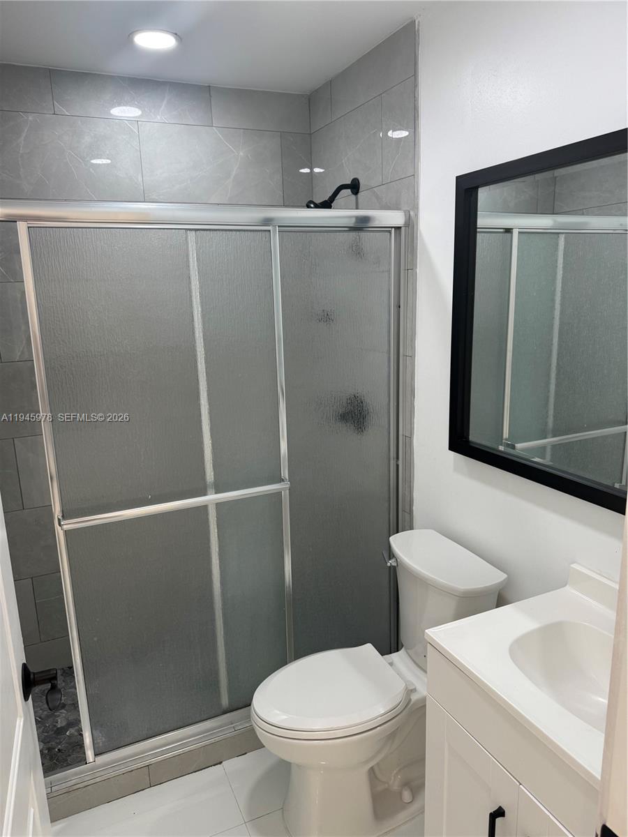 14320 Southwest 147th Court, Unit E1 Miami, FL 33196 - Photo 4 of 8 a bathroom with a toilet and a shower
