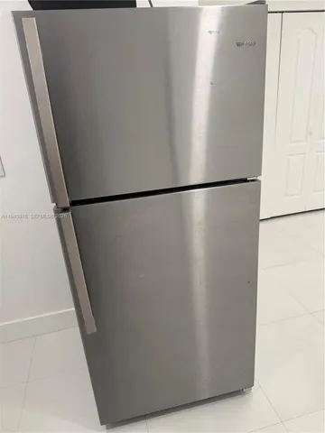 a silver refrigerator freezer sitting in a kitchen