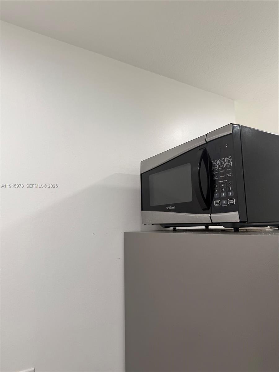 14320 Southwest 147th Court, Unit E1 Miami, FL 33196 - Photo 7 of 8 a silver refrigerator freezer sitting in a kitchen