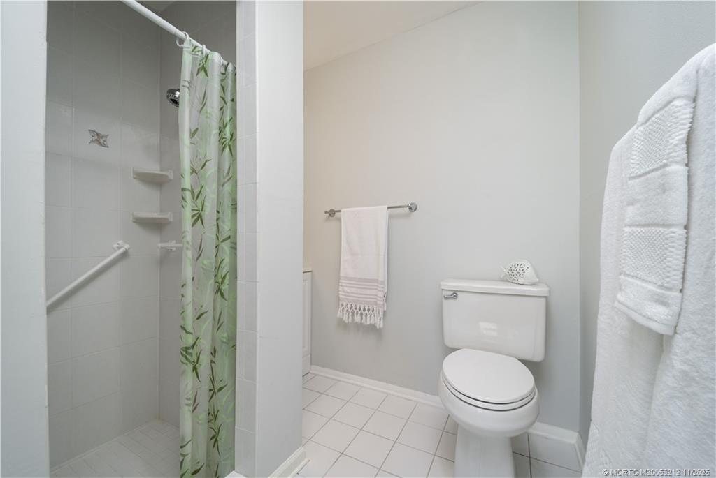 2929 Southeast Ocean Boulevard, Unit K1 Stuart, FL 34996 - Photo 10 of 26 a bathroom with a toilet and a shower