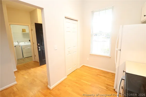 a view of a kitchen from a hallway