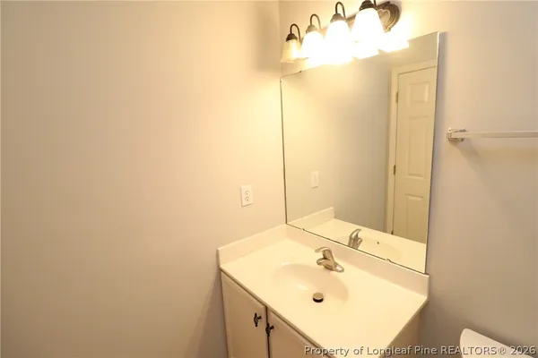 an empty room with a window and a ceiling fan