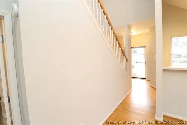 a view of a hallway with a white walls and stairs