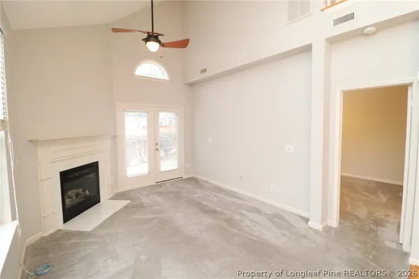a view of empty room with a fireplace and fan