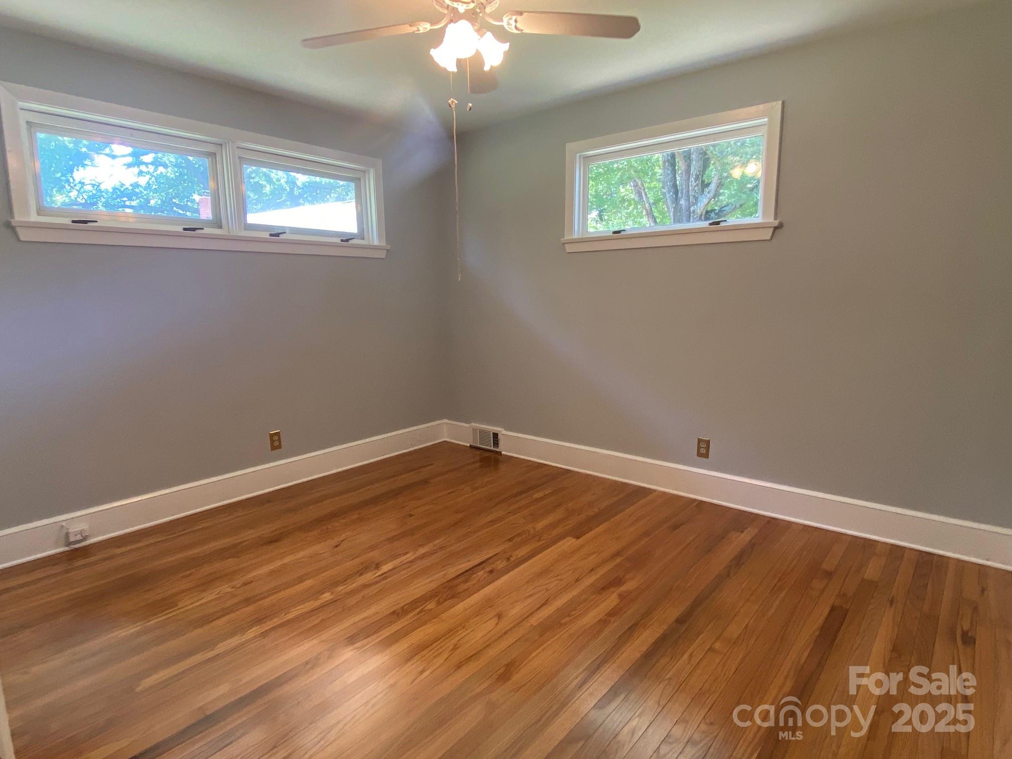 1017 Andover Road Charlotte, NC 28211 - Photo 13 of 20 a view of an empty room with wooden floor and a window