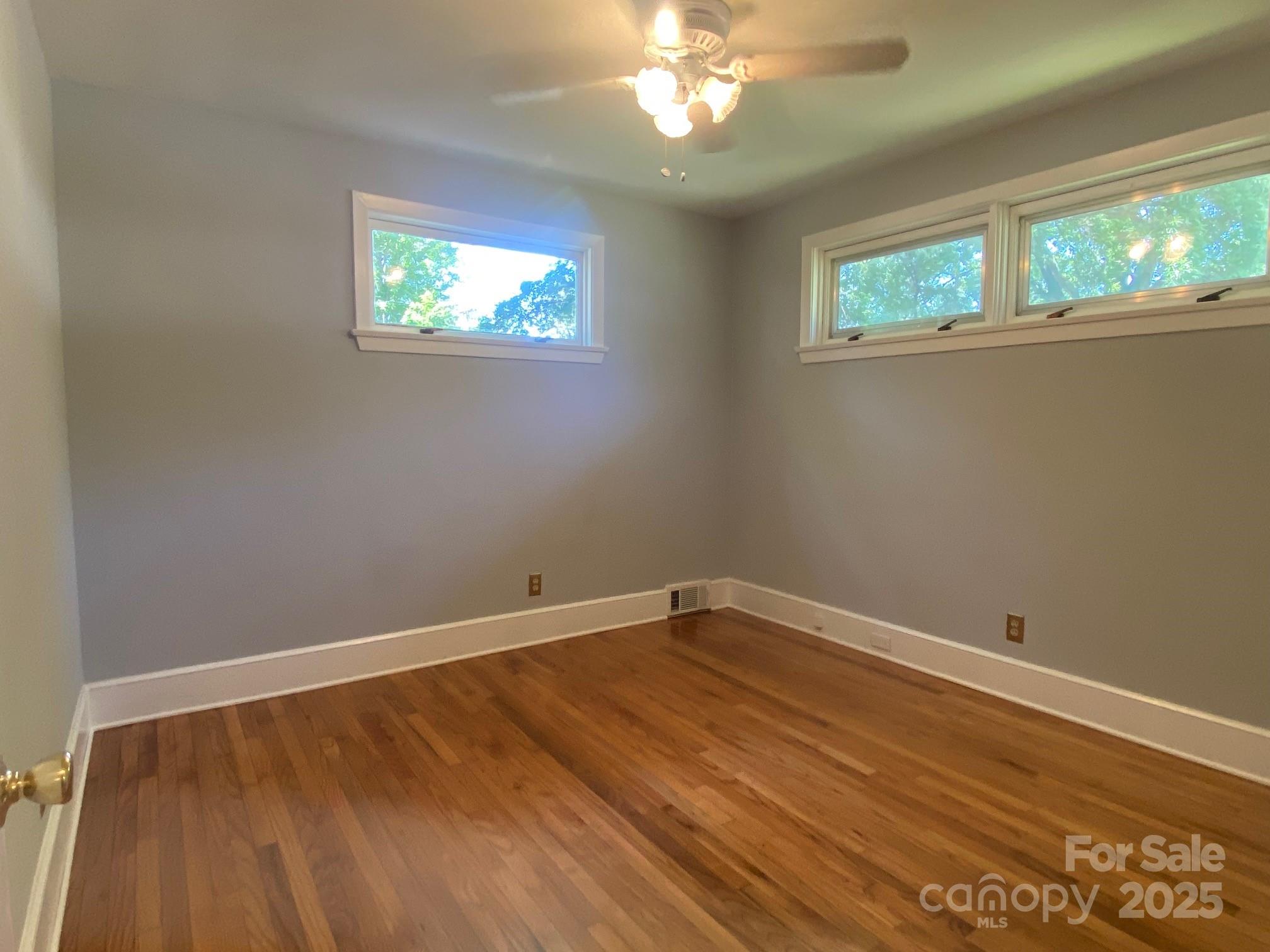 1017 Andover Road Charlotte, NC 28211 - Photo 14 of 20 a view of an empty room with wooden floor and a window