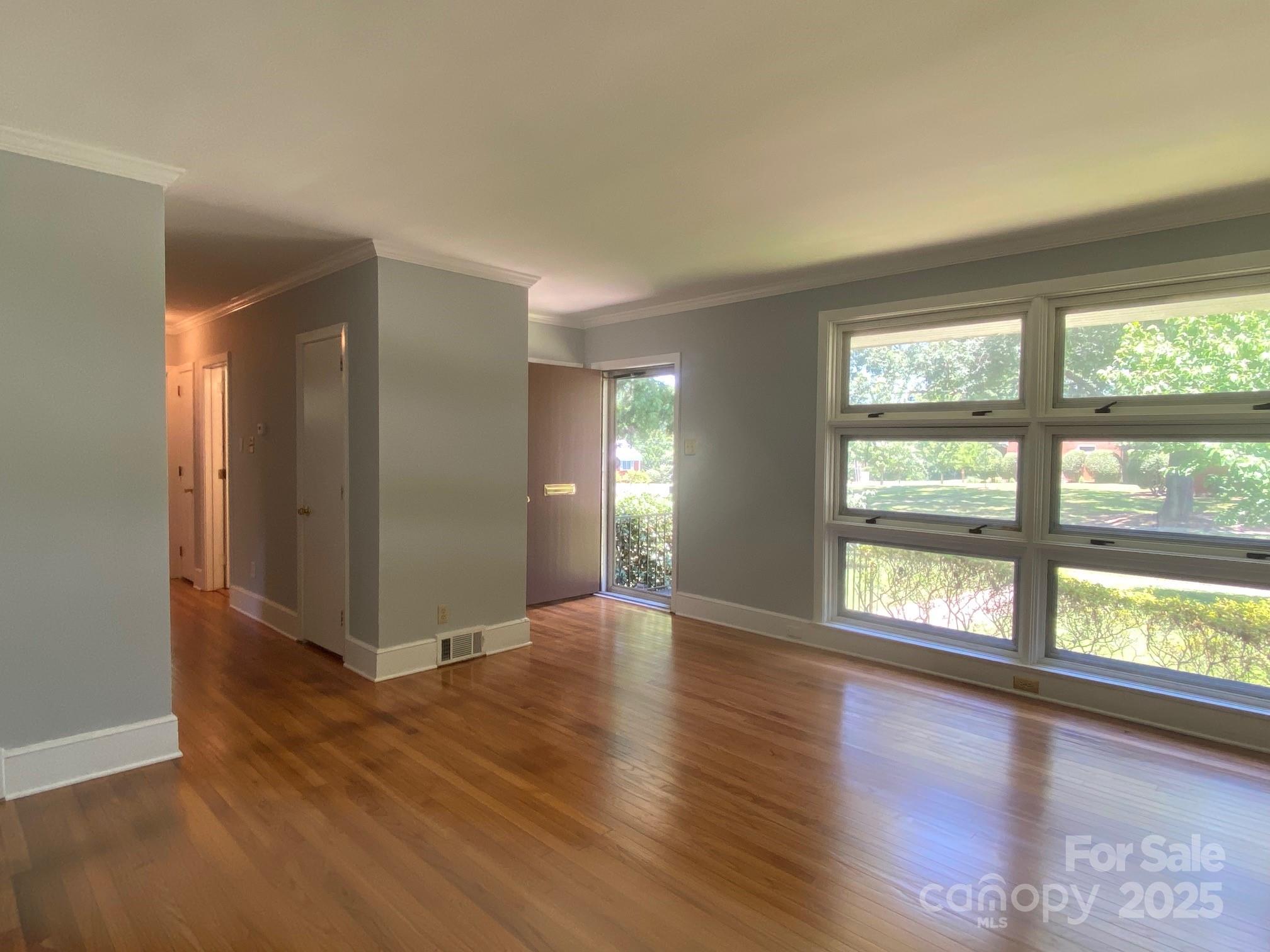 1017 Andover Road Charlotte, NC 28211 - Photo 5 of 20 an empty room with wooden floor and windows