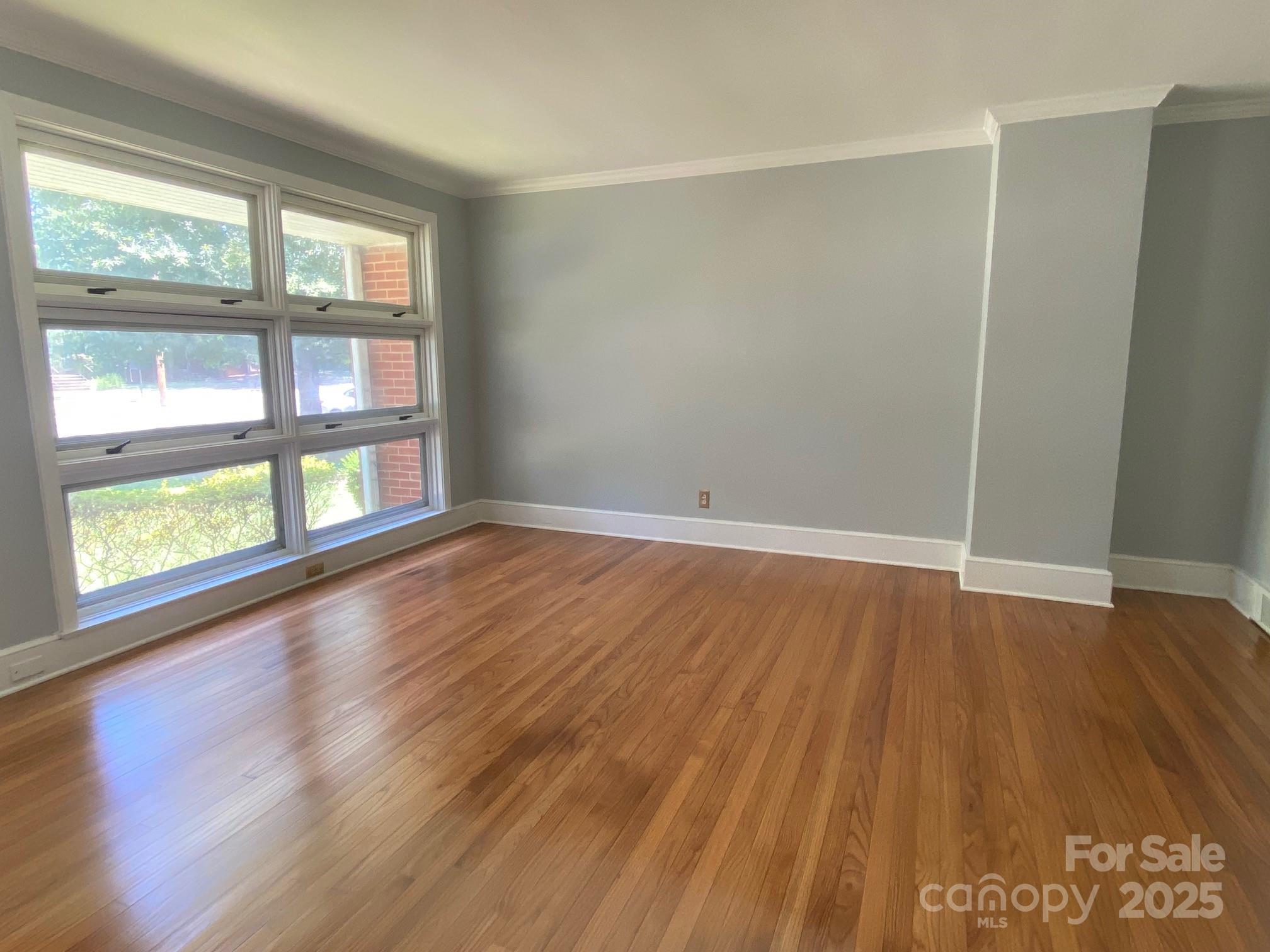 1017 Andover Road Charlotte, NC 28211 - Photo 6 of 20 an empty room with wooden floor and windows