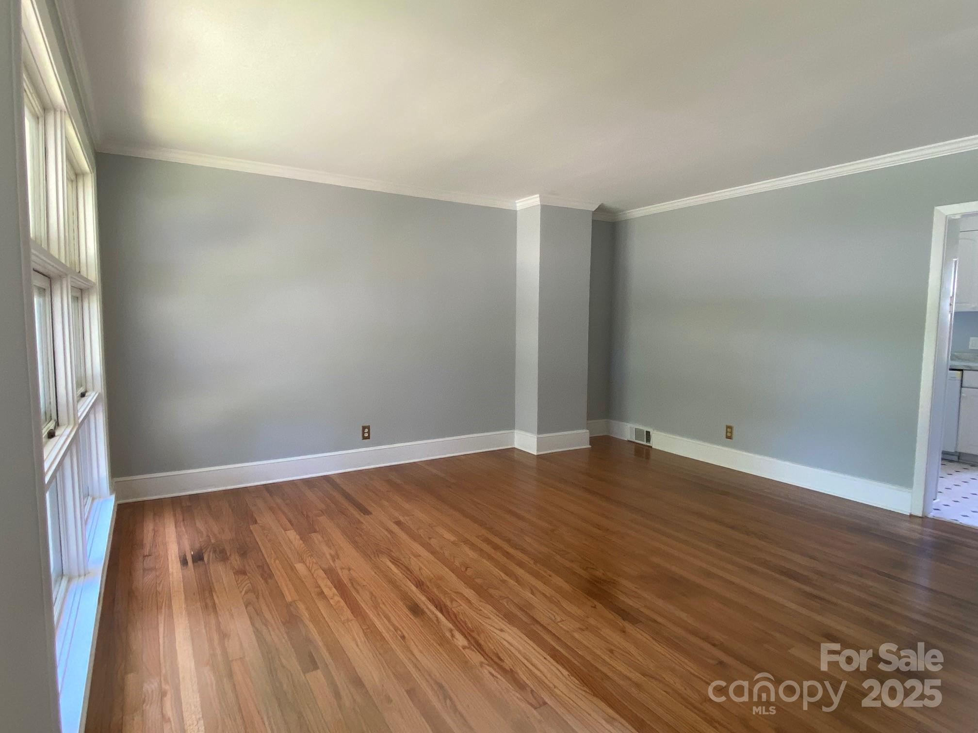 1017 Andover Road Charlotte, NC 28211 - Photo 7 of 20 an empty room with wooden floor and windows