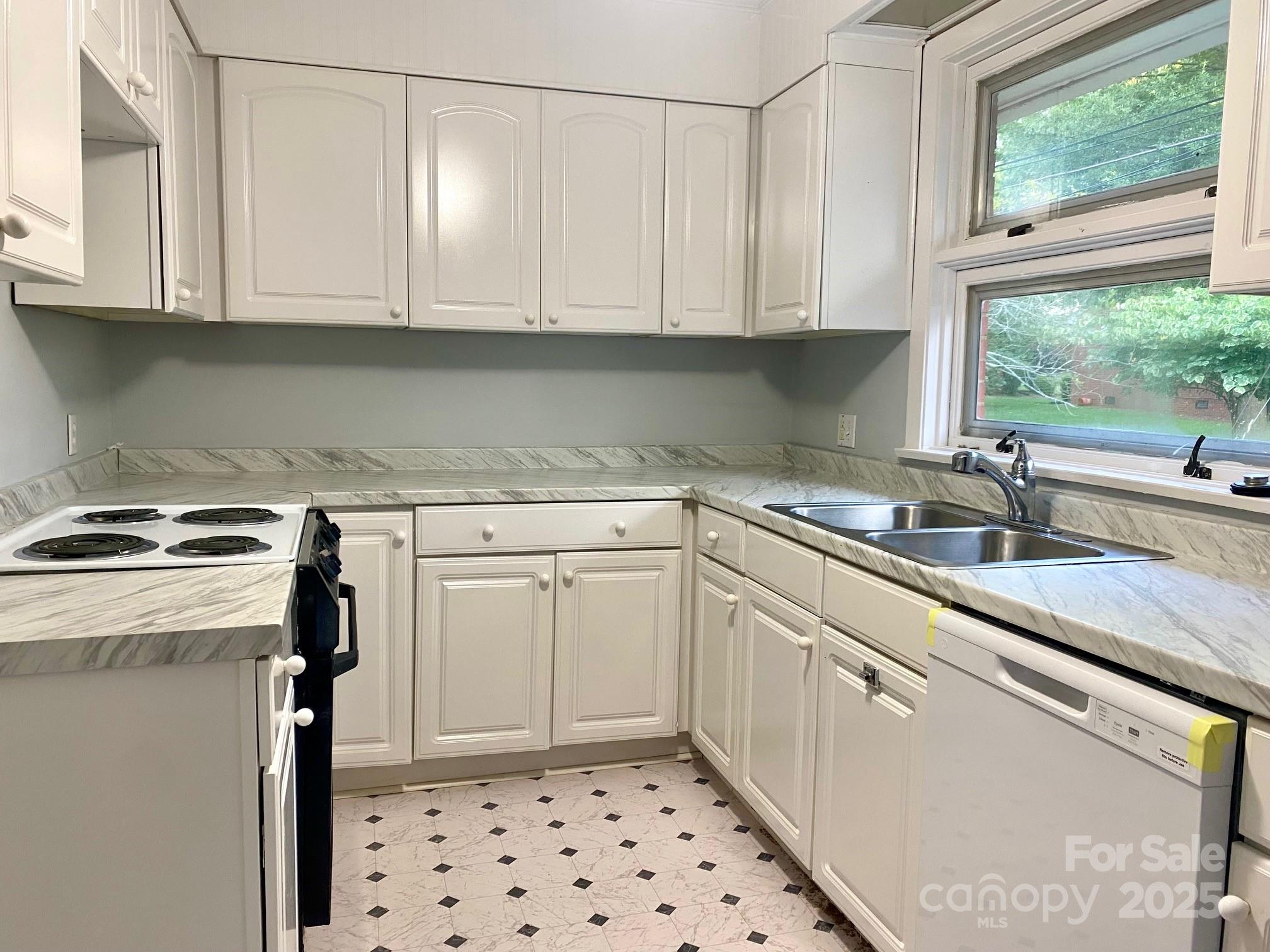 1017 Andover Road Charlotte, NC 28211 - Photo 8 of 20 a kitchen with granite countertop a sink a stove a microwave and cabinets