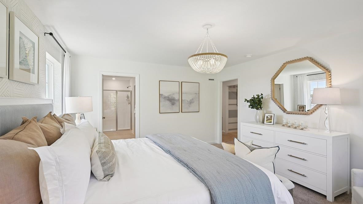 501 Scotty, Unit 1304 Rio Grande, NJ 08242 - Photo 30 of 41 a bedroom with a bed a chandelier and dresser