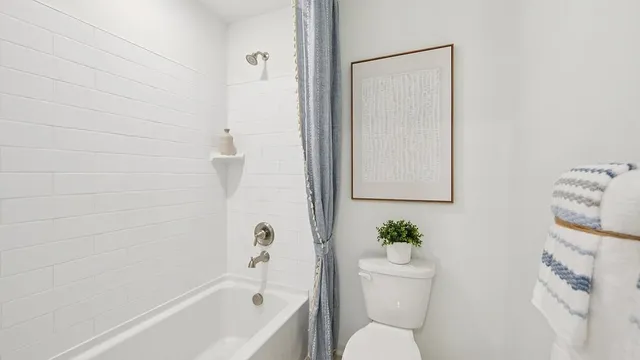 a bedroom with a bed a mirror and a window