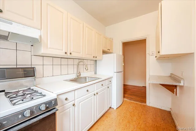 a kitchen with a sink stove and refrigerator