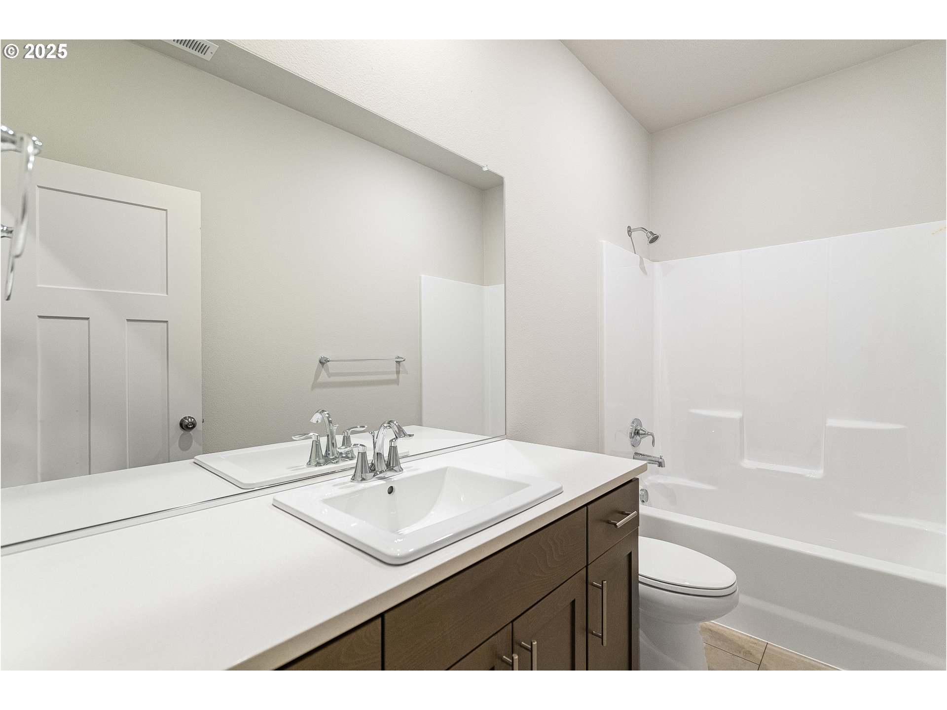 2607 South 6th Way Ridgefield, WA 98642 - Photo 11 of 32 a bathroom with a sink a toilet a shower and a mirror