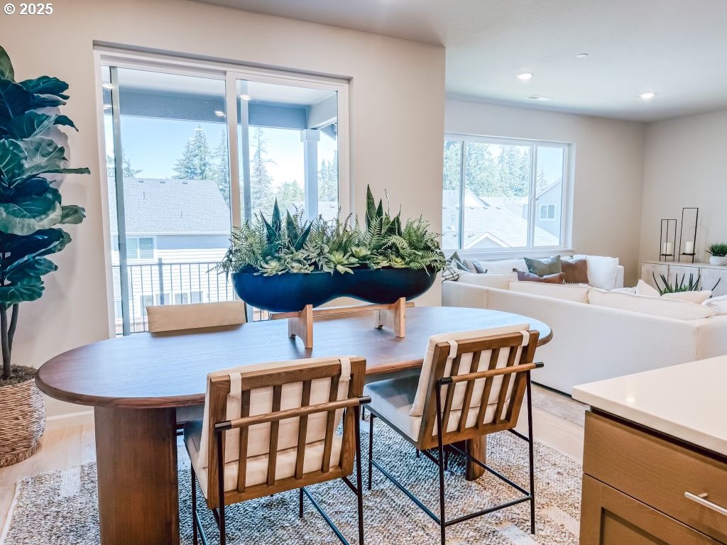2607 South 6th Way Ridgefield, WA 98642 - Photo 19 of 32 a view of a dining room with furniture and a potted plant
