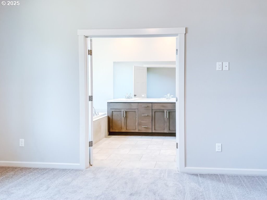 2607 South 6th Way Ridgefield, WA 98642 - Photo 25 of 32 a view of a bathroom with a sink and a mirror