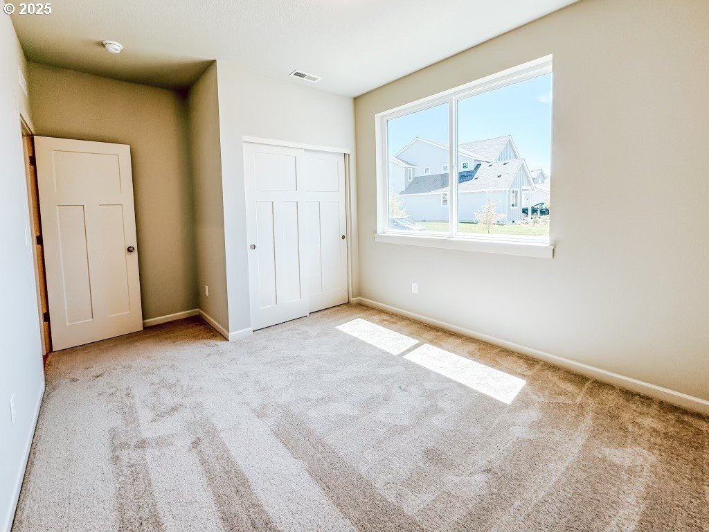 2607 South 6th Way Ridgefield, WA 98642 - Photo 8 of 32 a view of an empty room with window and bathroom