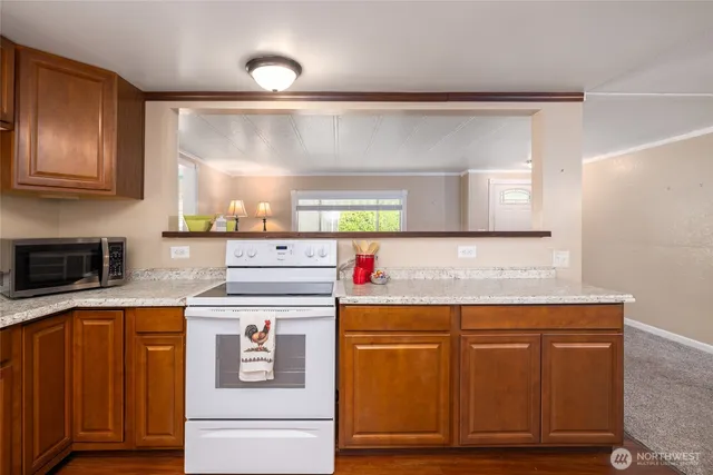 a kitchen with a sink cabinets and wooden floor