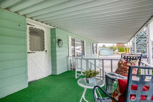 a balcony with furniture and a potted plant