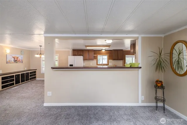 a view of an empty room with window and cabinet