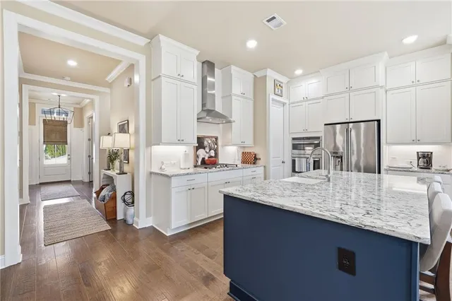 a kitchen with stainless steel appliances granite countertop a sink refrigerator and cabinets