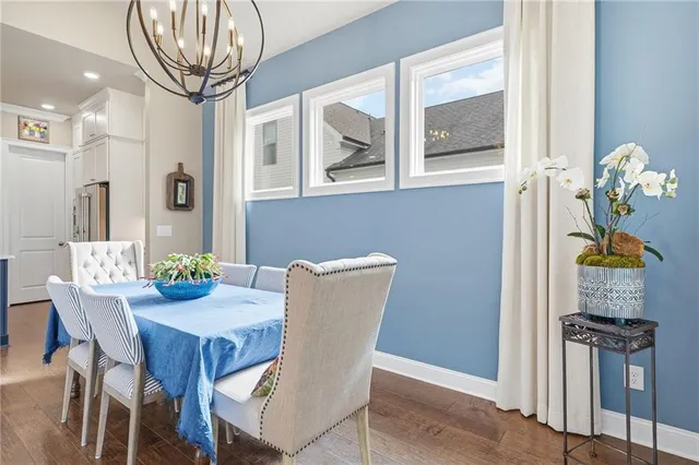 a view of a dining room with furniture wooden floor and chandelier