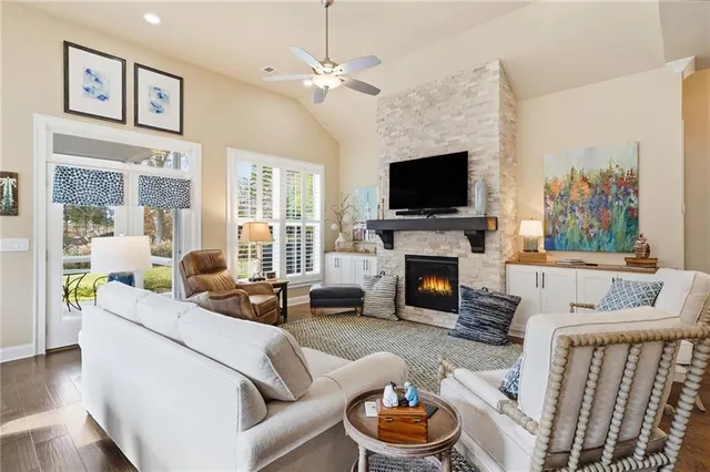 a living room with furniture a fireplace and a flat screen tv