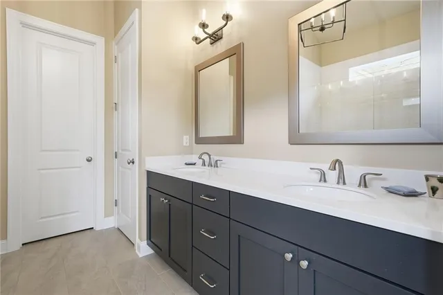 a bathroom with a double vanity sink and mirror