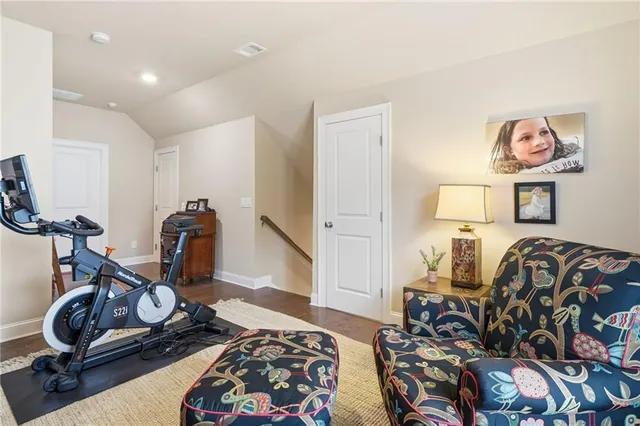 a room with gym equipment and a rug