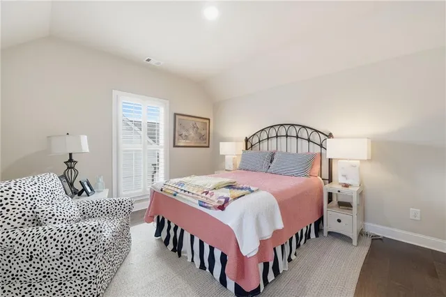 a bedroom with a bed window and a table in it